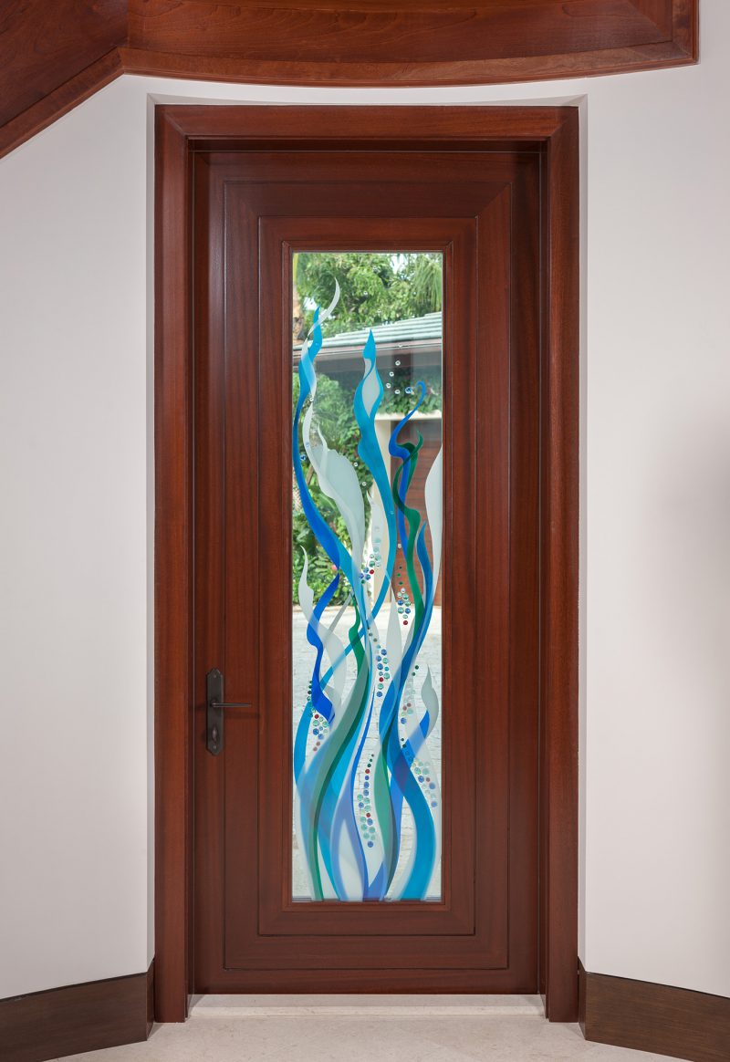 Doorway with a modern and contemporary style of white, blue, and green colored glass.