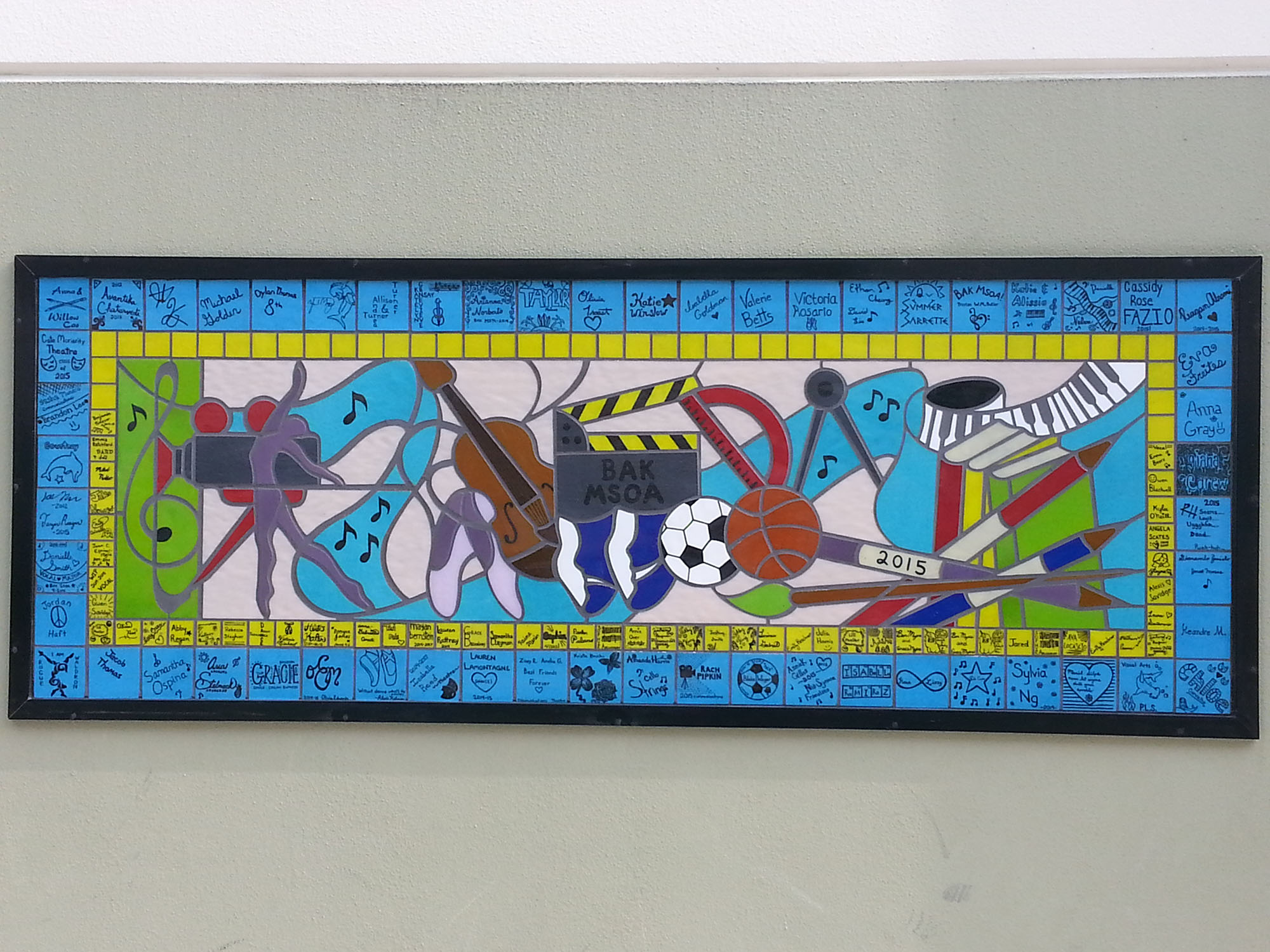 Traditional style mosaic of artistic objects with many colorful pieces of glass in blue and yellow.