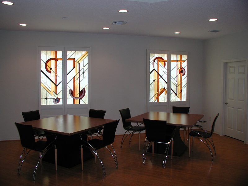 Interior office space with two stained glass windows. Warm colors and modern design.