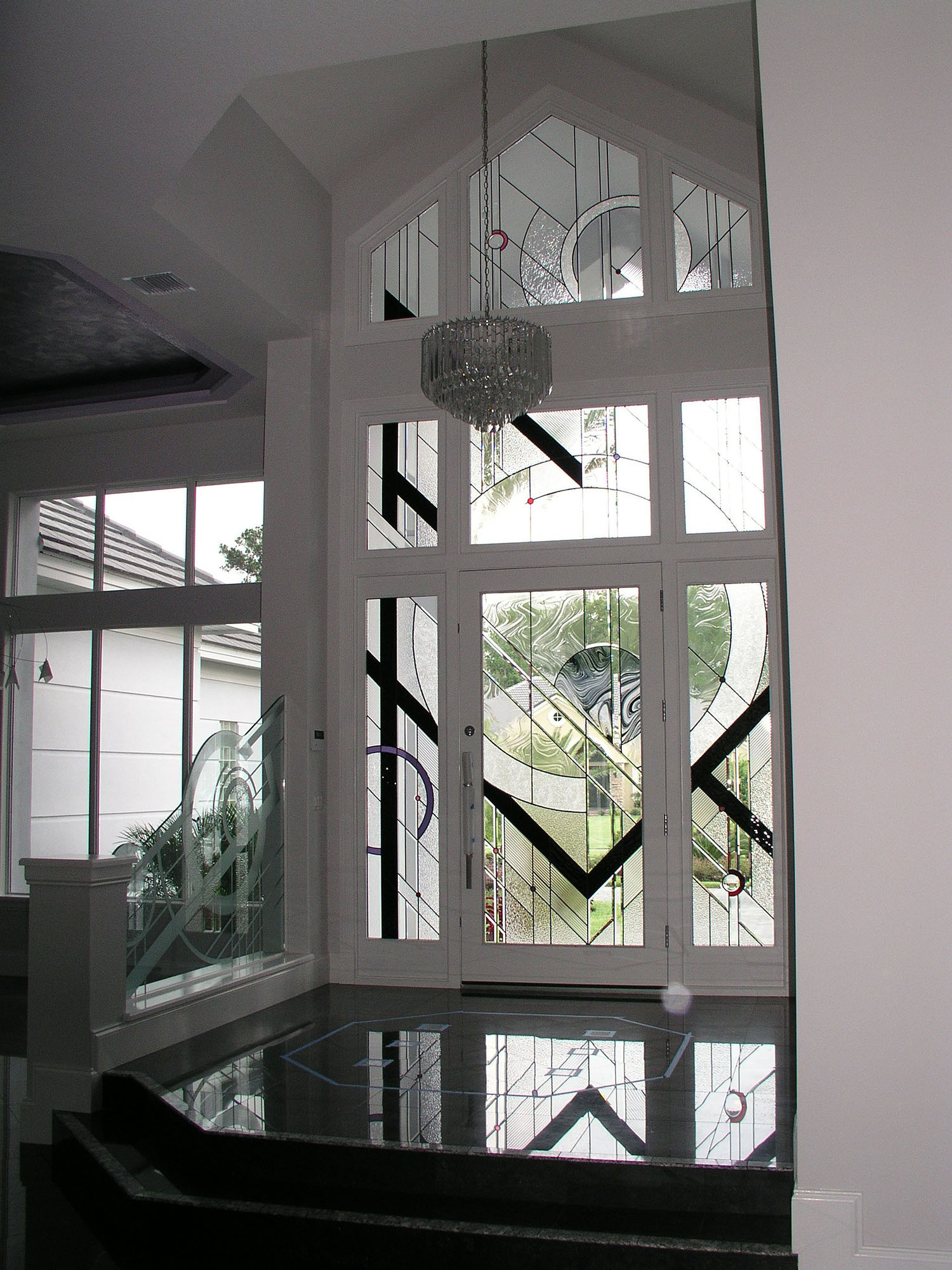 Modern and contemporary entryway with black, clear, and clear textured glass.