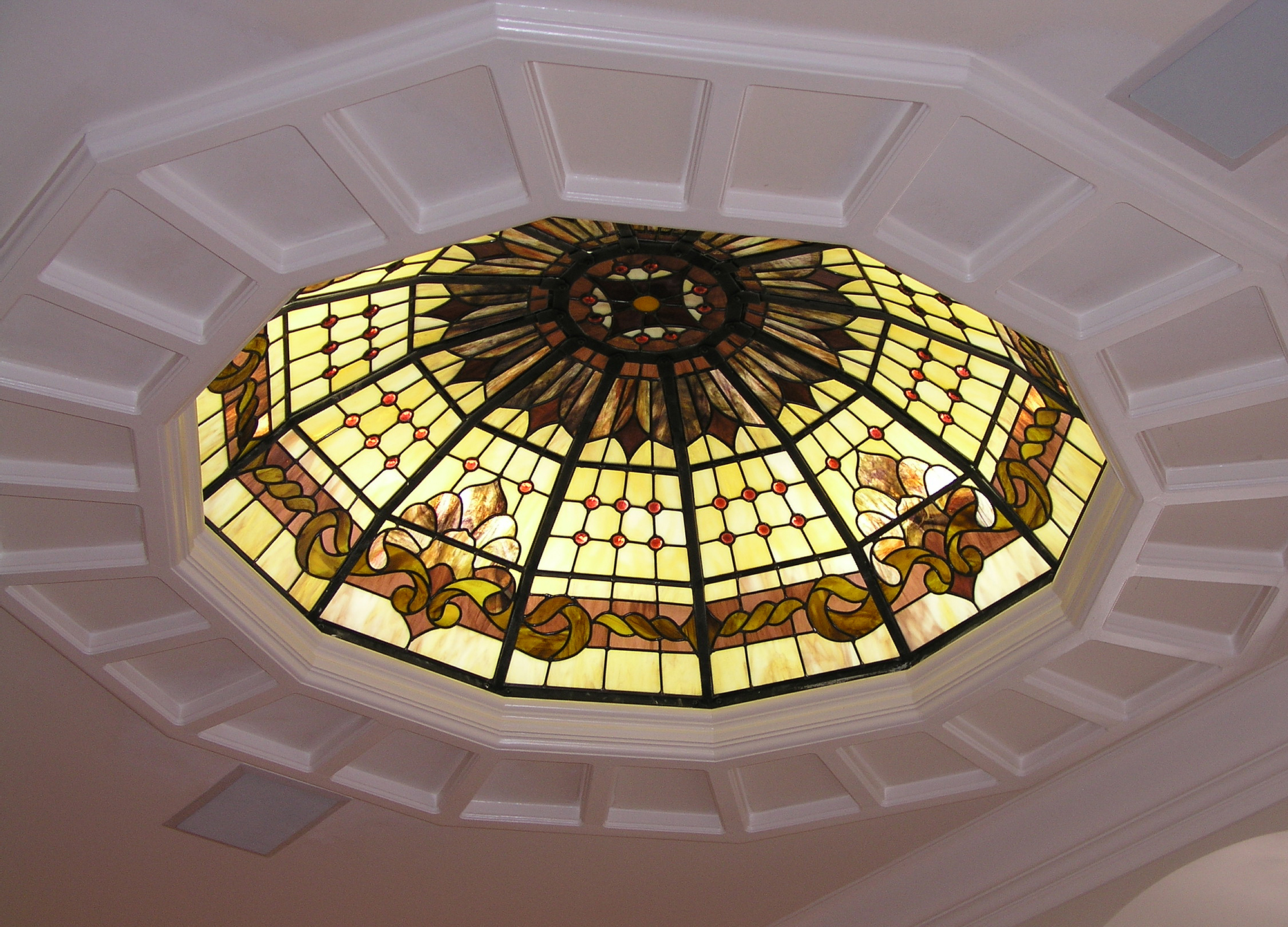 Ceiling dome with yellow, tan, beige, and brown glass in a Traditional style.