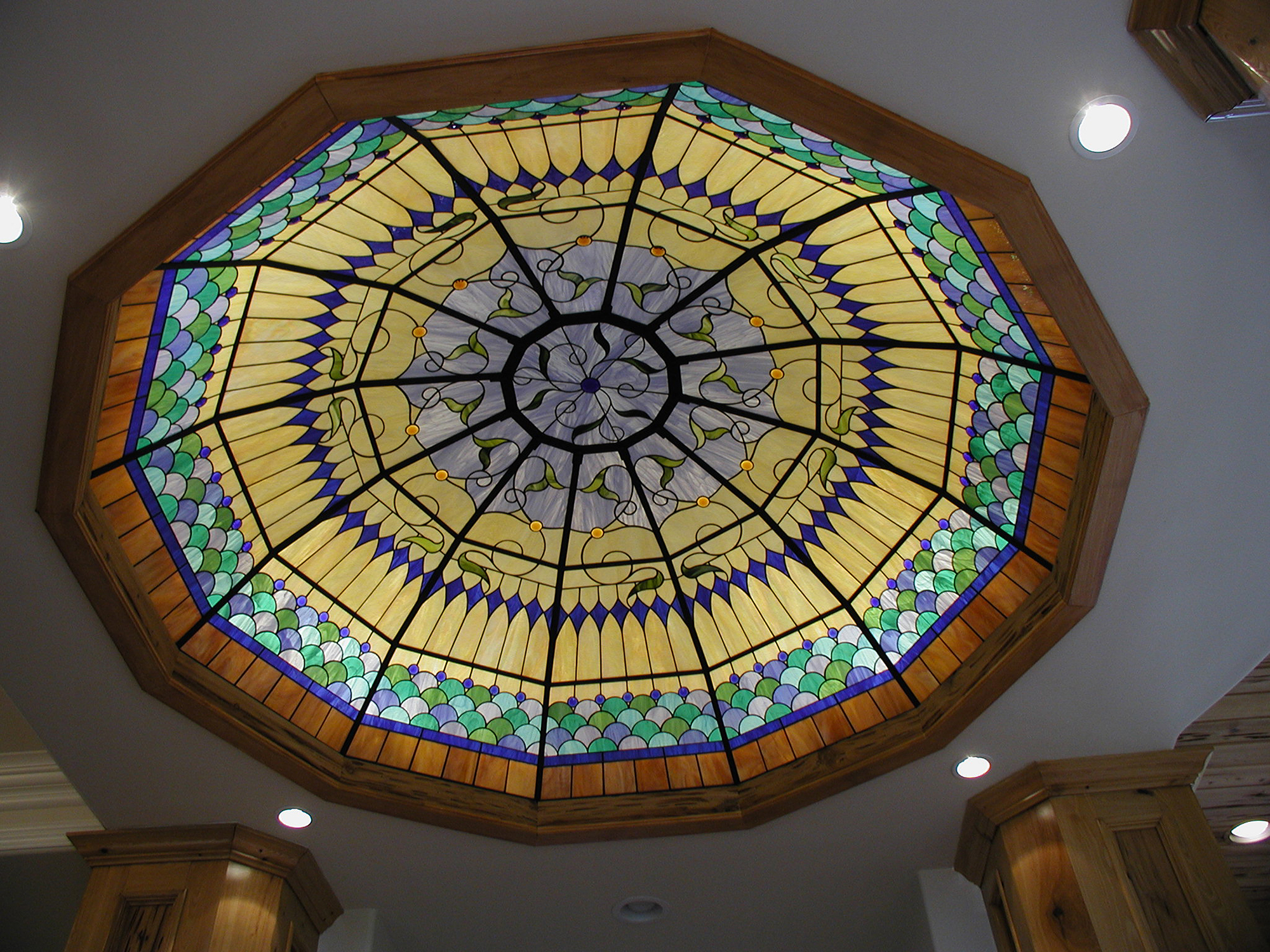 Ceiling dome with yellow, blue, green, and brown glass in a Traditional style.