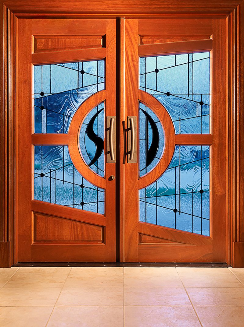 wooden doors with modern linear stained glass design, black jewels accents