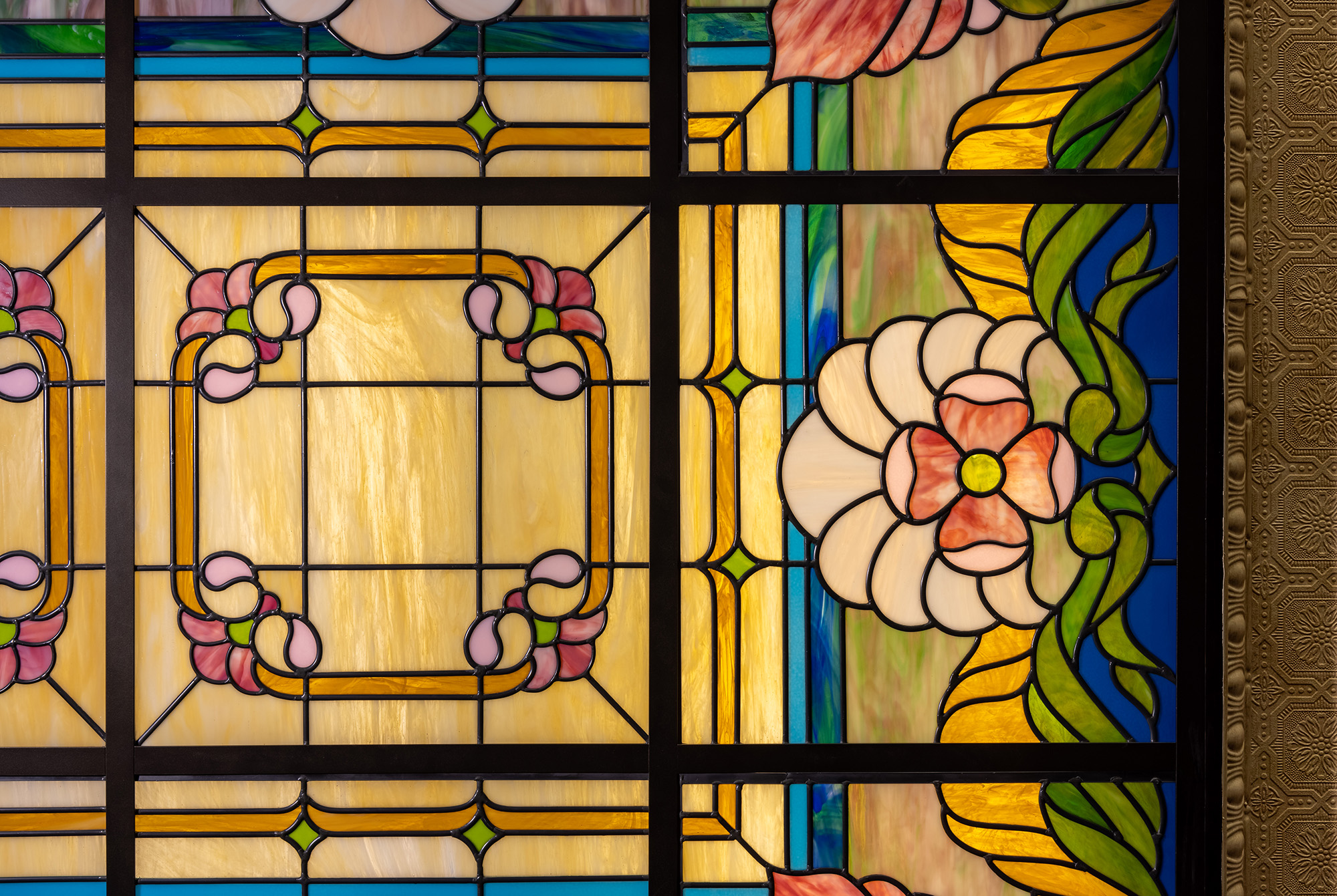 Detail photo of amber, pink, blue and green art nouveau style skylight