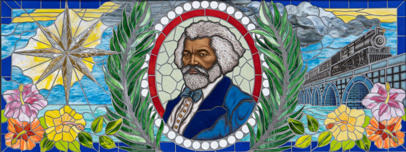 Public art mosaic of Frederick Douglass with blue glass, colorful flowers, and a train on a bridge in a traditional style.