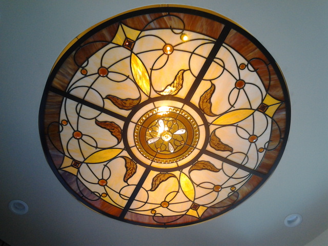 Ceiling light dome with brown, beige, and yellow glass in a Traditional style.