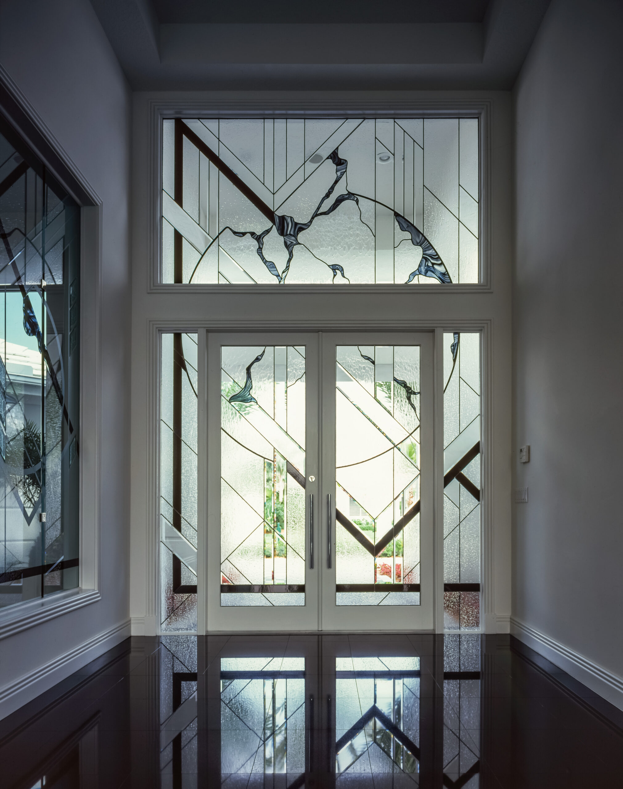 Contemporary and modern entryway with black, clear, and clear textured glass.
