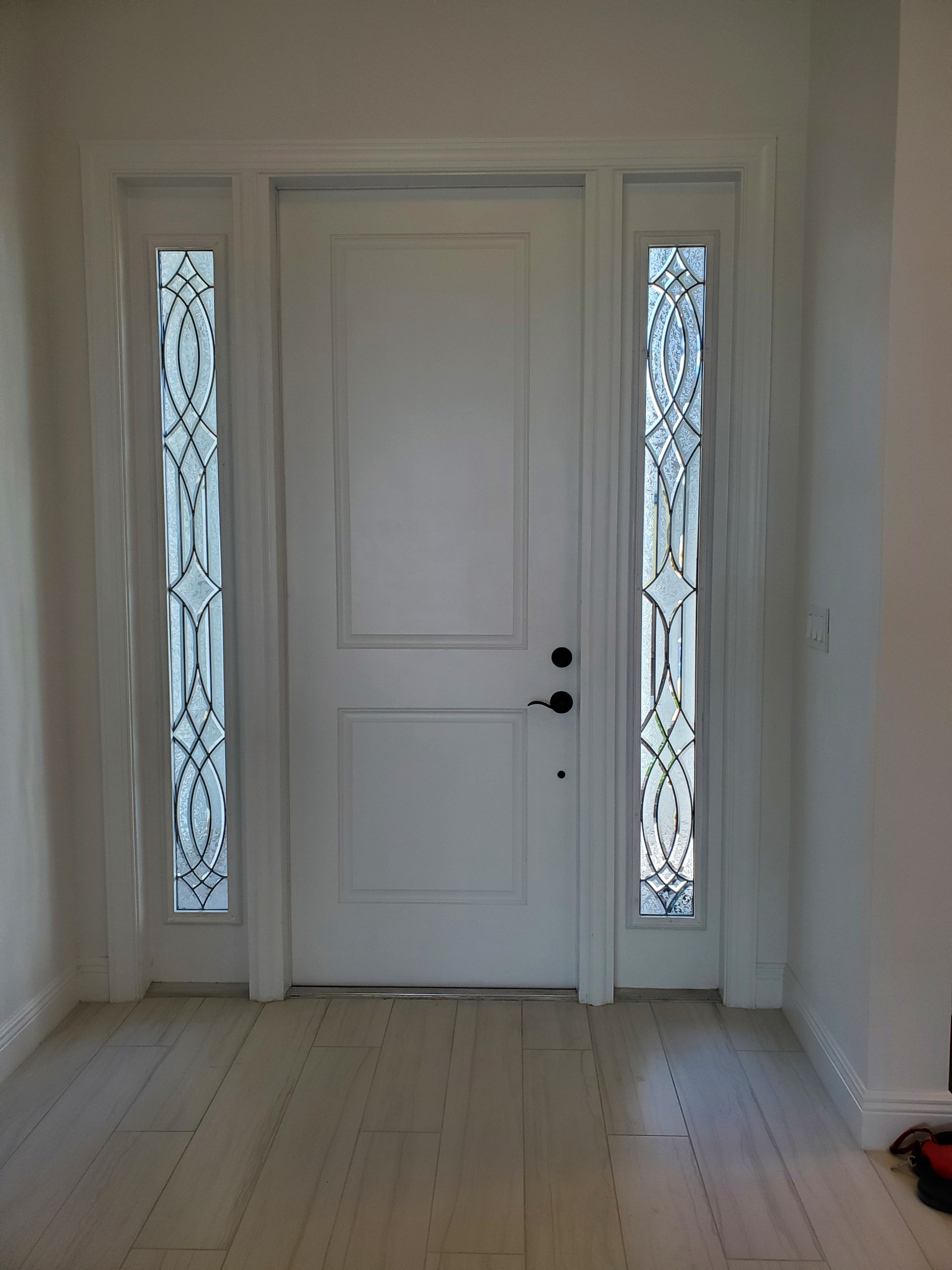 Small stained glass windows in entryway with clear textured glass in a Contemporary style.