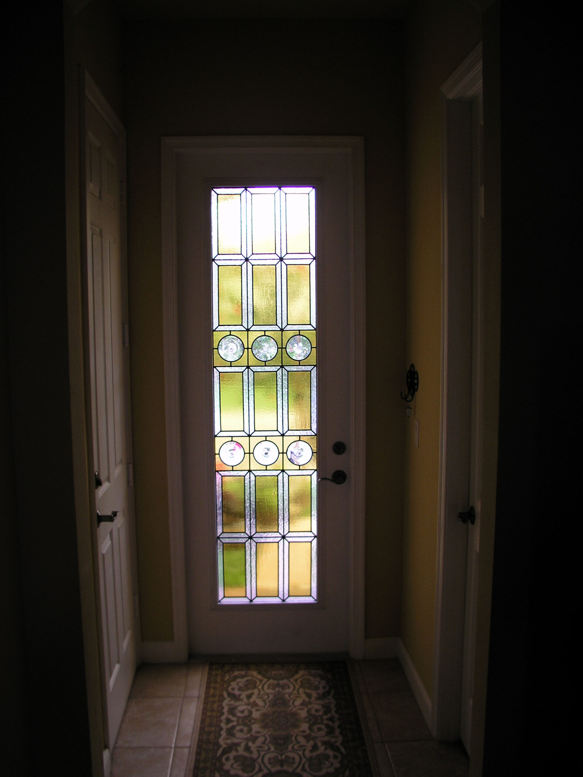 Small doorway with rondels, yellow, and cleat textured glass in a Traditional style.