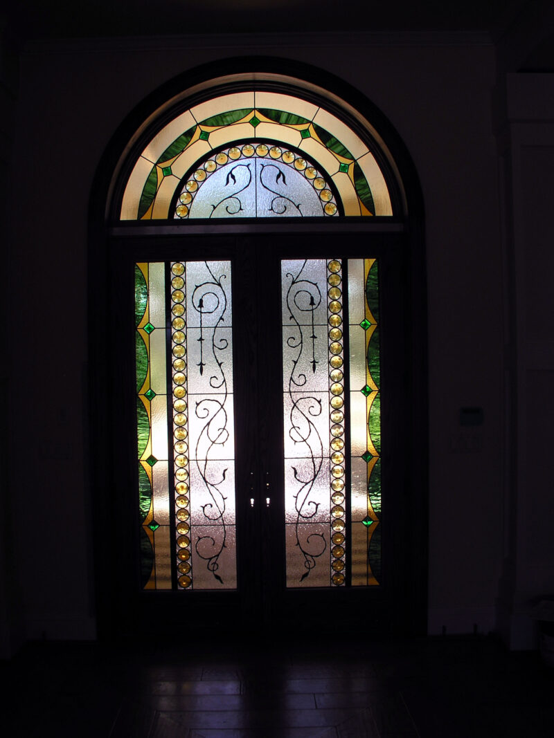 Entryway with green, yellow, beige, and clear textured glass and rondels in a Traditional style.