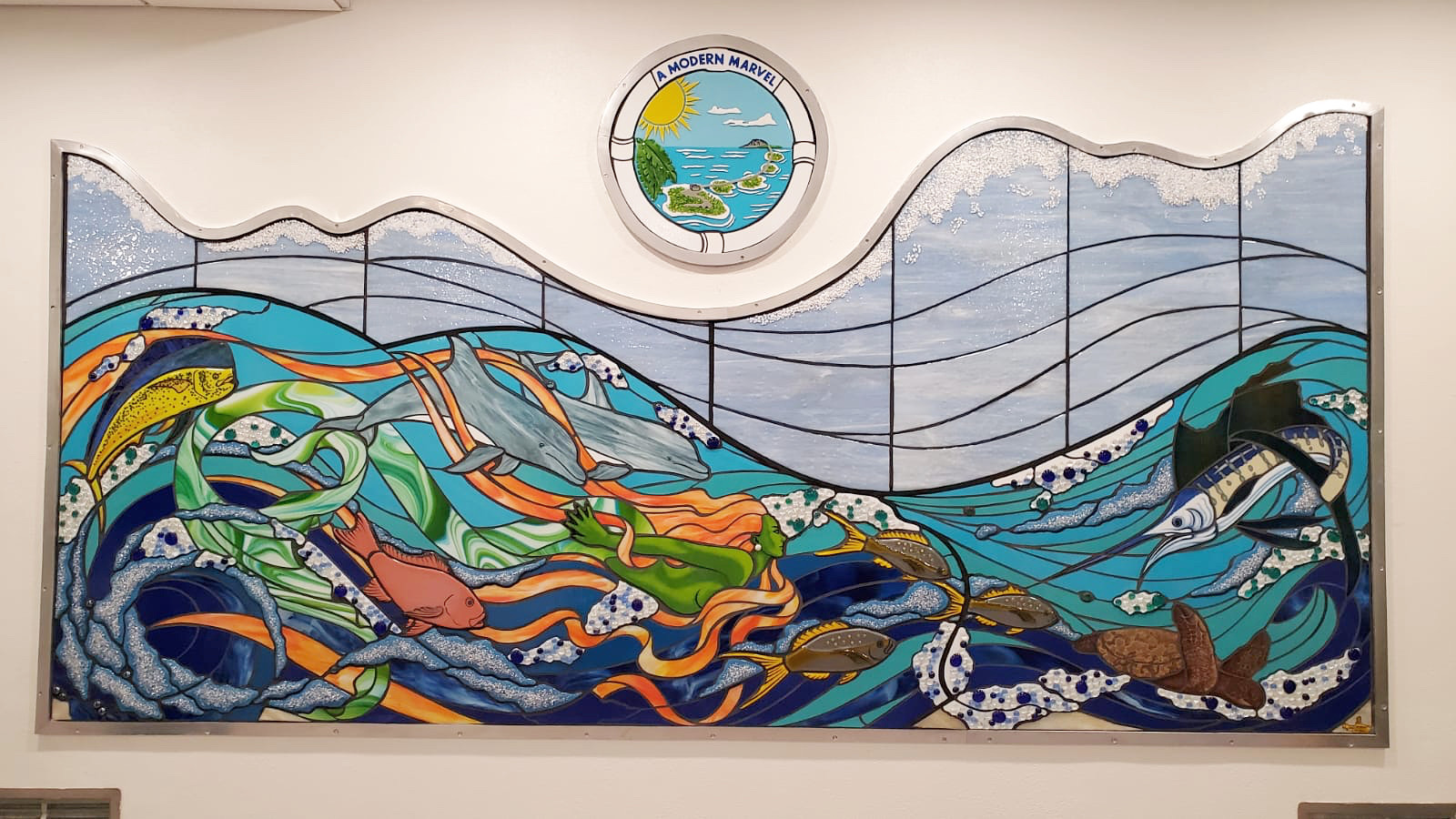 glass mosaic with various sea life, green mermaid, waves